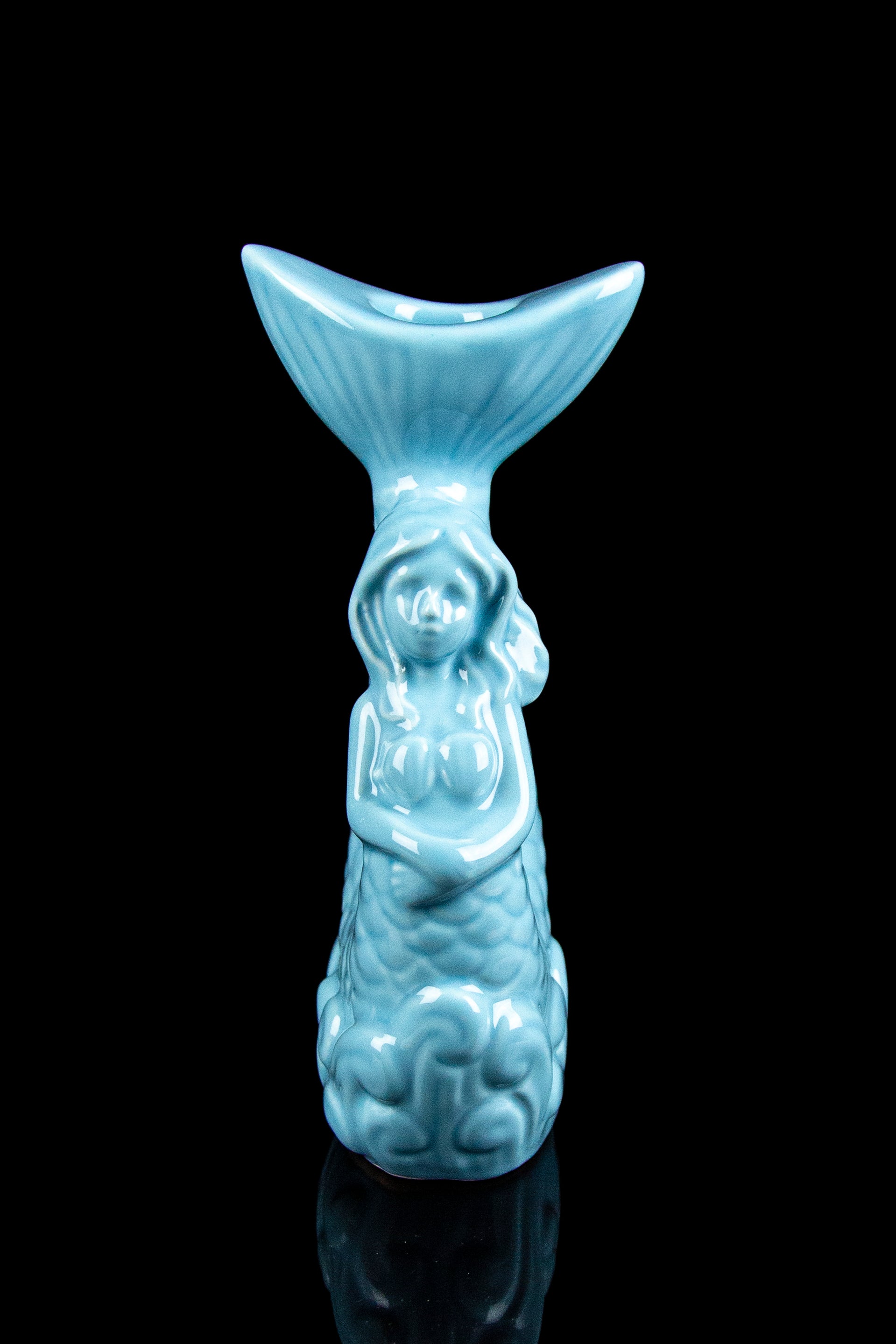 Ceramic, turquoise-glazed sculpture of a smiling Buddha with a wide, bowl-shaped head, resembling a pipe or dab rig.