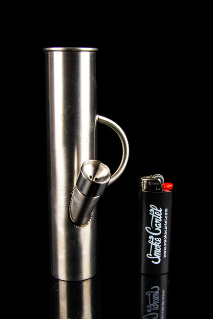 Silver glass pipe and black lighter with "Smoke Cartel" branding against a black background. 