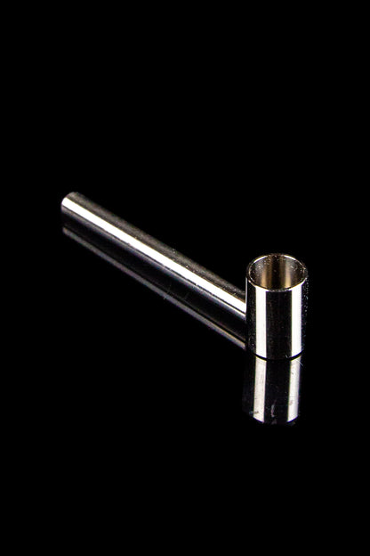 Silver one-hitter pipe against a black background.