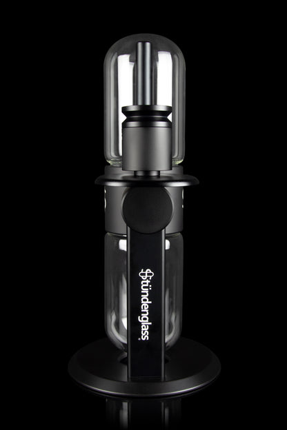 Sündglass black silicone nectar collector with glass tip, isolated on a black background.