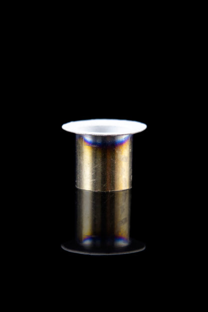 Metallic cannabis oil burner with reflective surface, isolated on black.