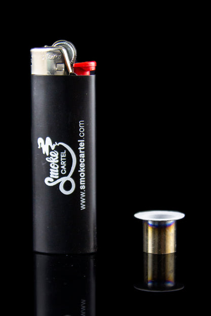 Black lighter with "Smoke Cartel" branding and website address, reflected on a dark surface.