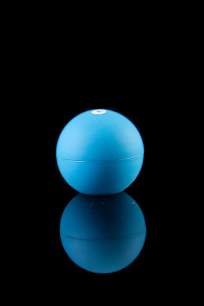 Blue silicone container with a reflective surface, likely for cannabis concentrates or oils.
