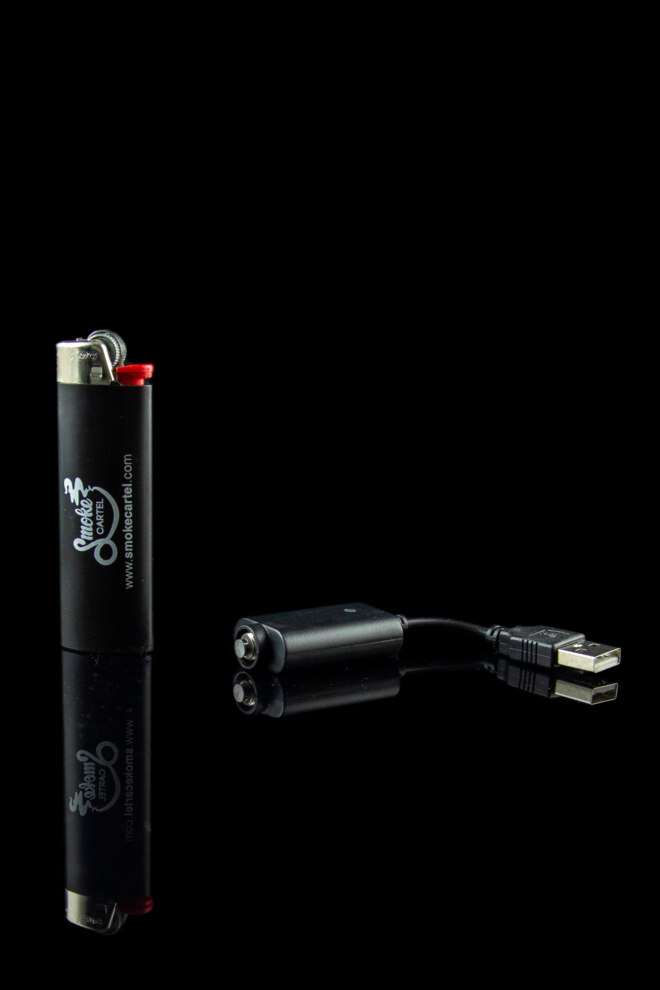 Black lighter and portable charger with USB cable on a dark background.