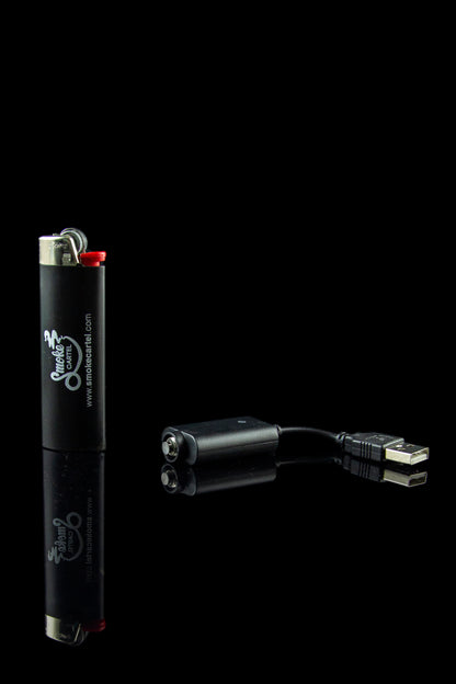 Black lighter and portable charger with USB cable on a dark background.