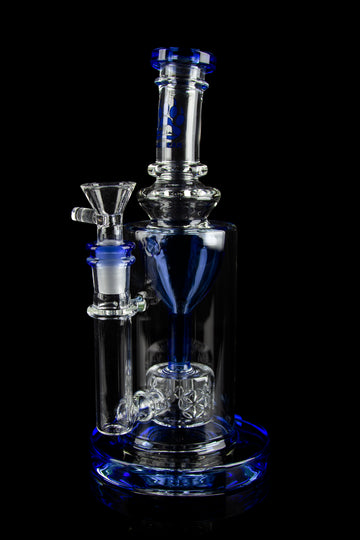 A clear glass water pipe (bong) with blue accents, featuring intricate curves and a removable bowl piece, set against a black background. - Calibear "Sundae Stack" Torus Recycler Water Pipe