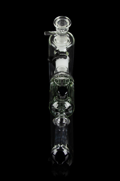 Clear glass bubbler water pipe against a black background.