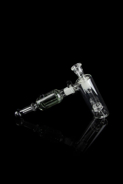 Clear glass rig with intricate bubbler and joint connection, isolated on black.