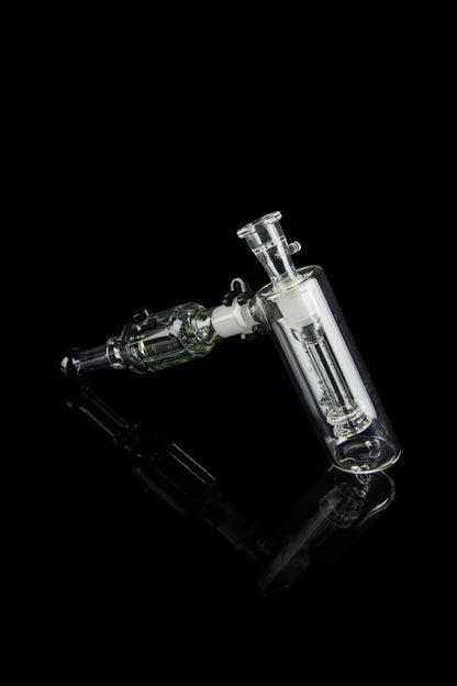Clear glass water pipe (rig) with intricate bubbler design, isolated on black.