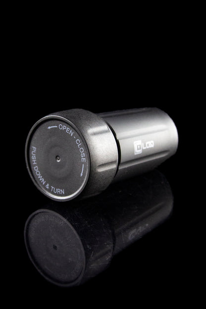 Close-up of a cannabis oil cartridge with a twisting, child-resistant cap, and a partially visible cartridge body.