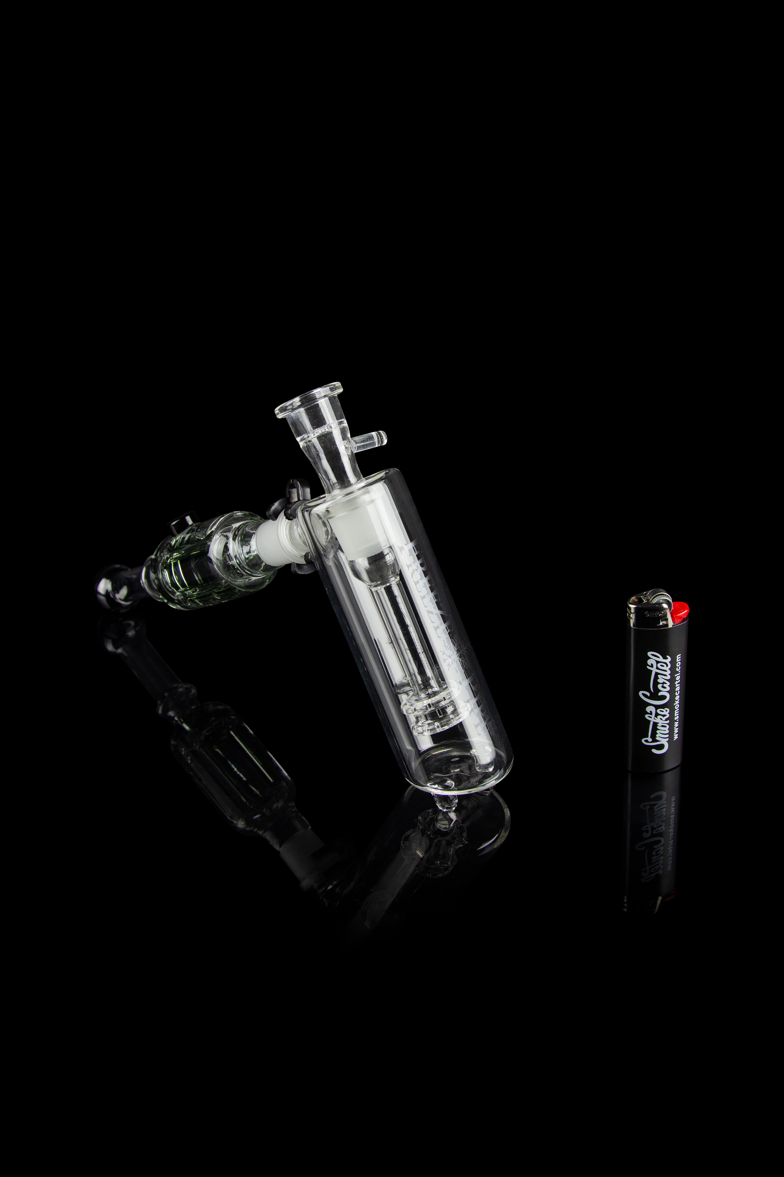 Glass bubbler water pipe with intricate design against a black background.