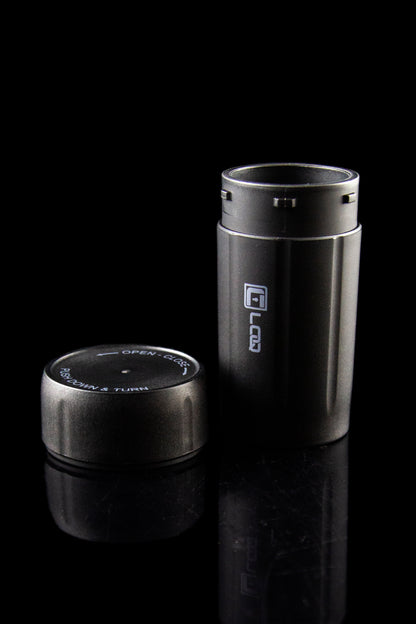 Black cannabis oil vape pen with open/close cap displayed on a reflective surface.