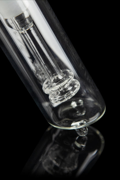 Close-up of a clear glass bong with intricate percolators against a black background.
