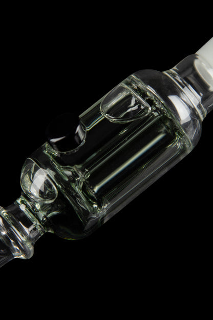 Clear glass bubbler with intricate swirling design, isolated on black.