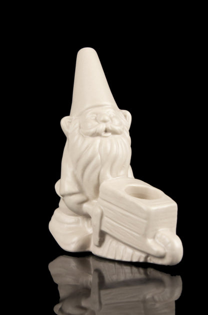 White ceramic garden gnome pipe, studio shot on a reflective surface.