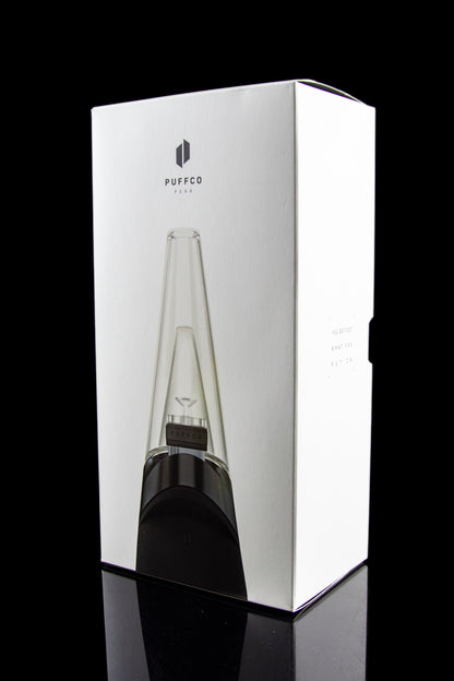 Puffco Peak portable dab rig with glass water pipe, displayed in its white packaging.