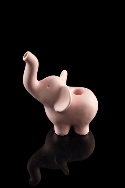 Pink ceramic elephant-shaped pipe with a glossy reflection on a black background.