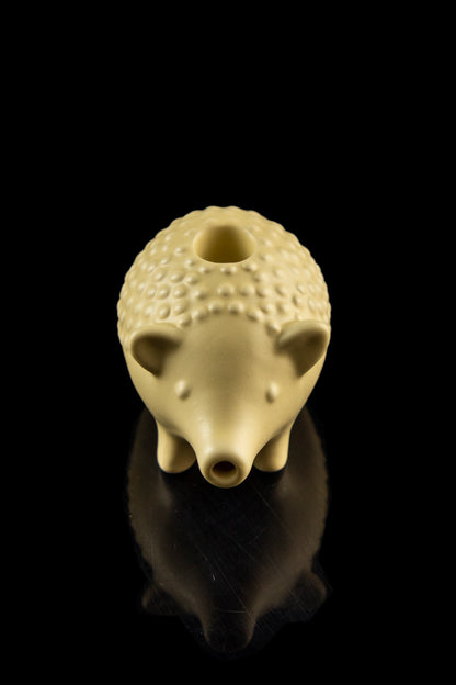 Ceramic pipe shaped like a hedgehog with a glossy finish, displayed against a black background.