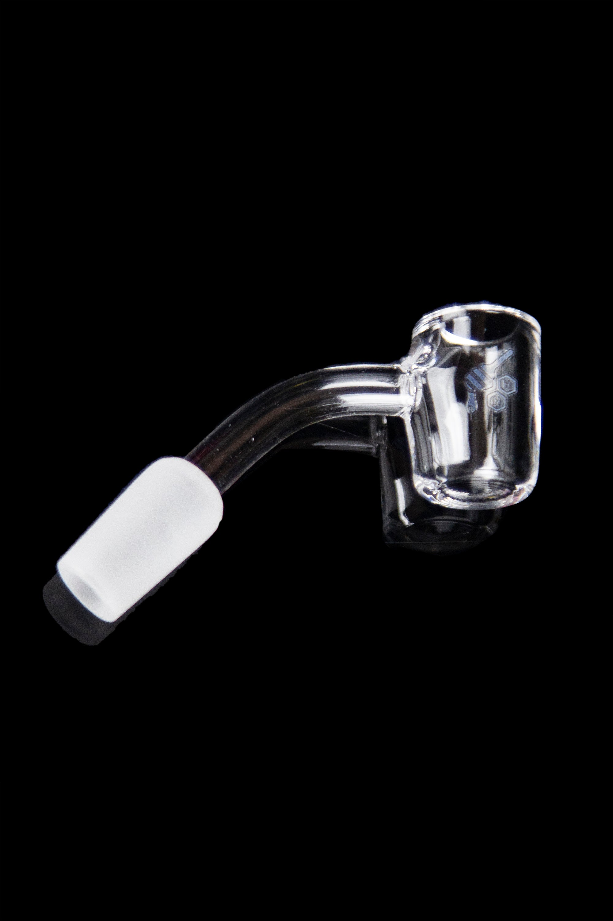 Clear quartz dab nail with a white ceramic insert, isolated on a black background.