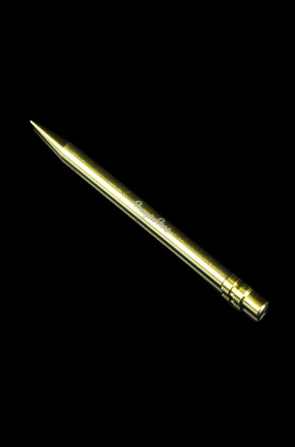 Gold cannabis dab tool on a black background.