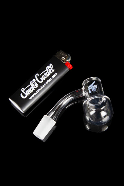 Glass oil rig with a carb cap and butane lighter against a black background.