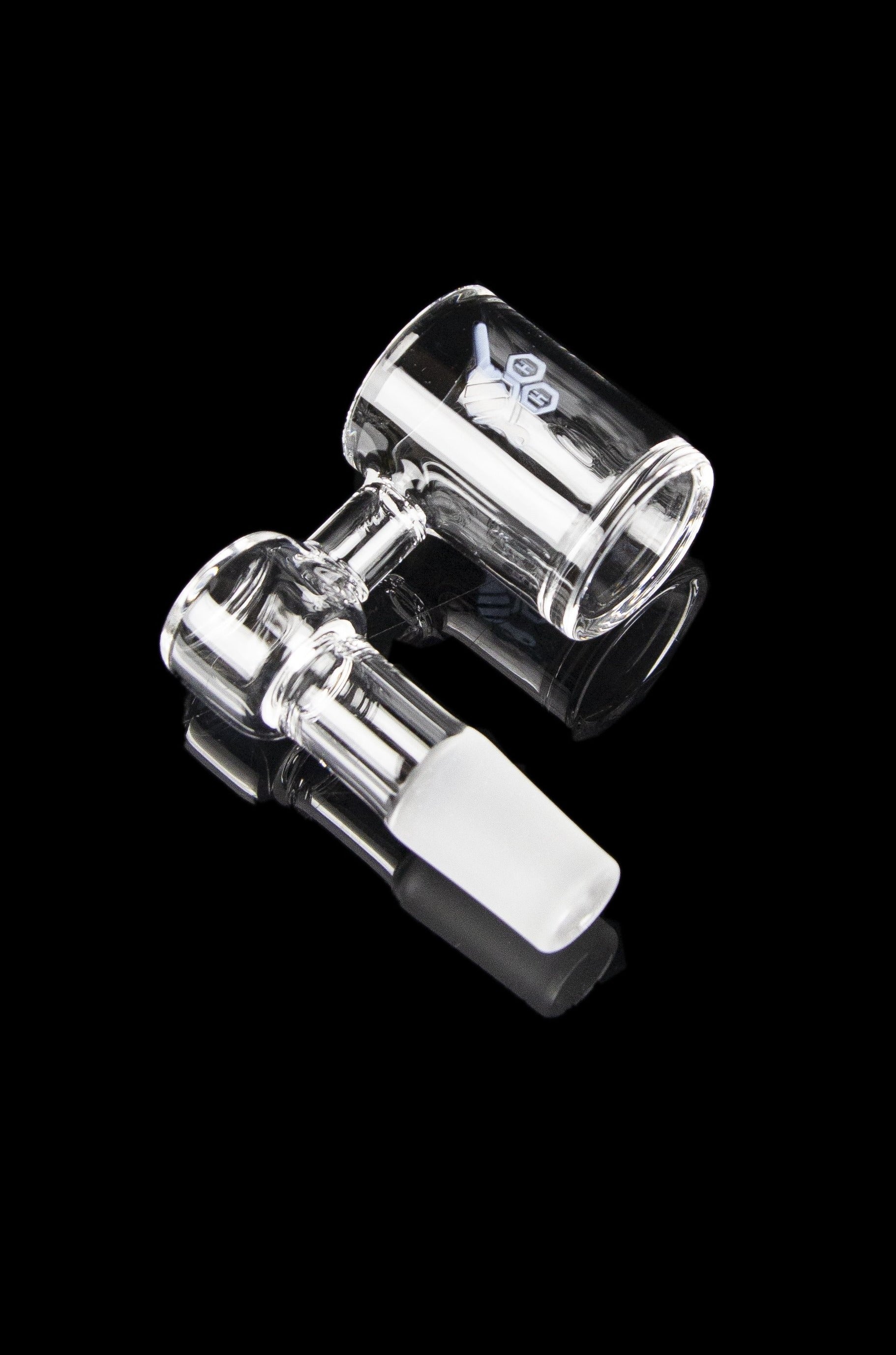 Clear glass dab rig with accompanying carb cap, isolated on a black background.