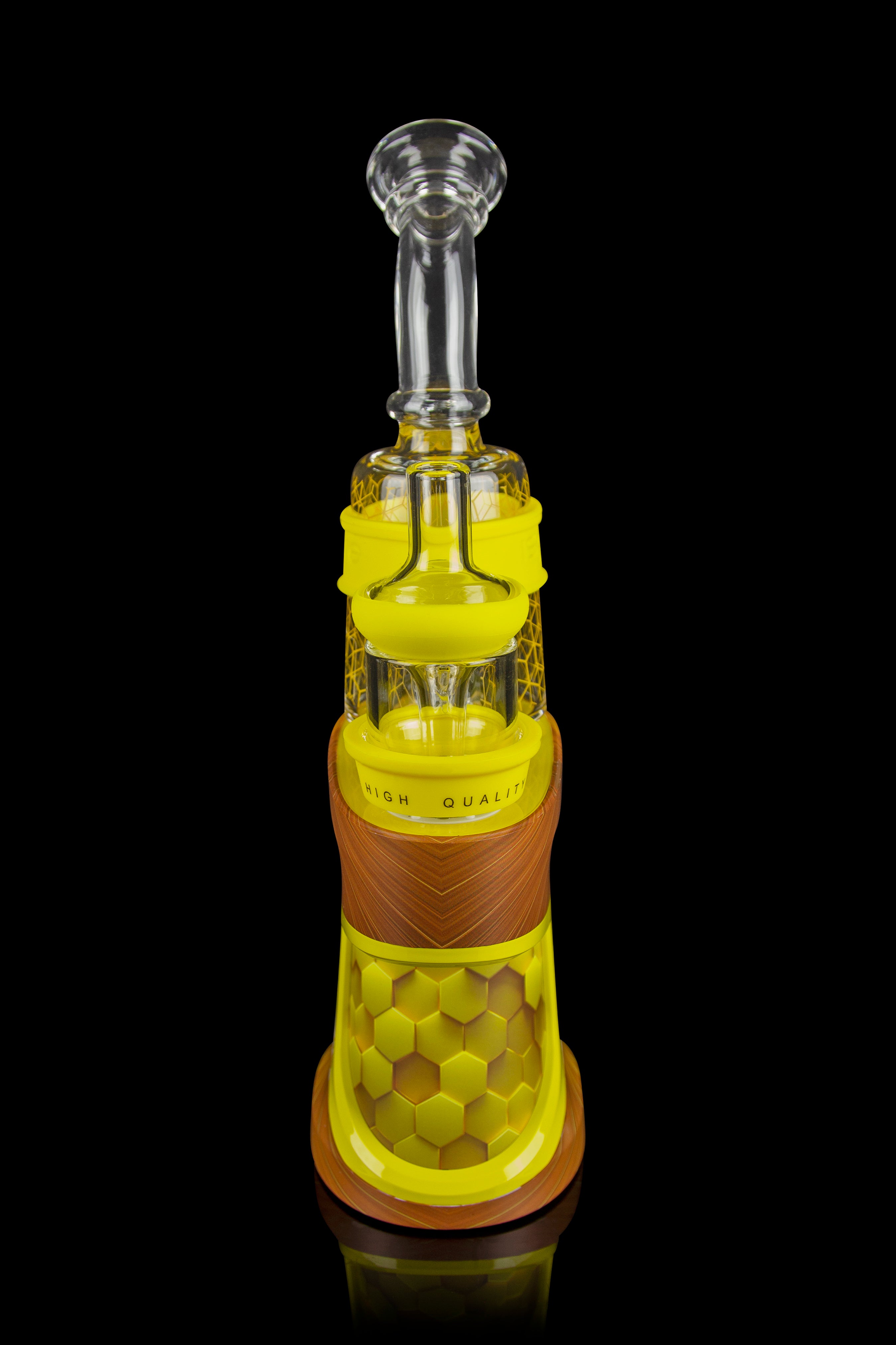 Yellow glass rig with intricate honeycomb detailing and clear mouthpiece, isolated on a black background.
