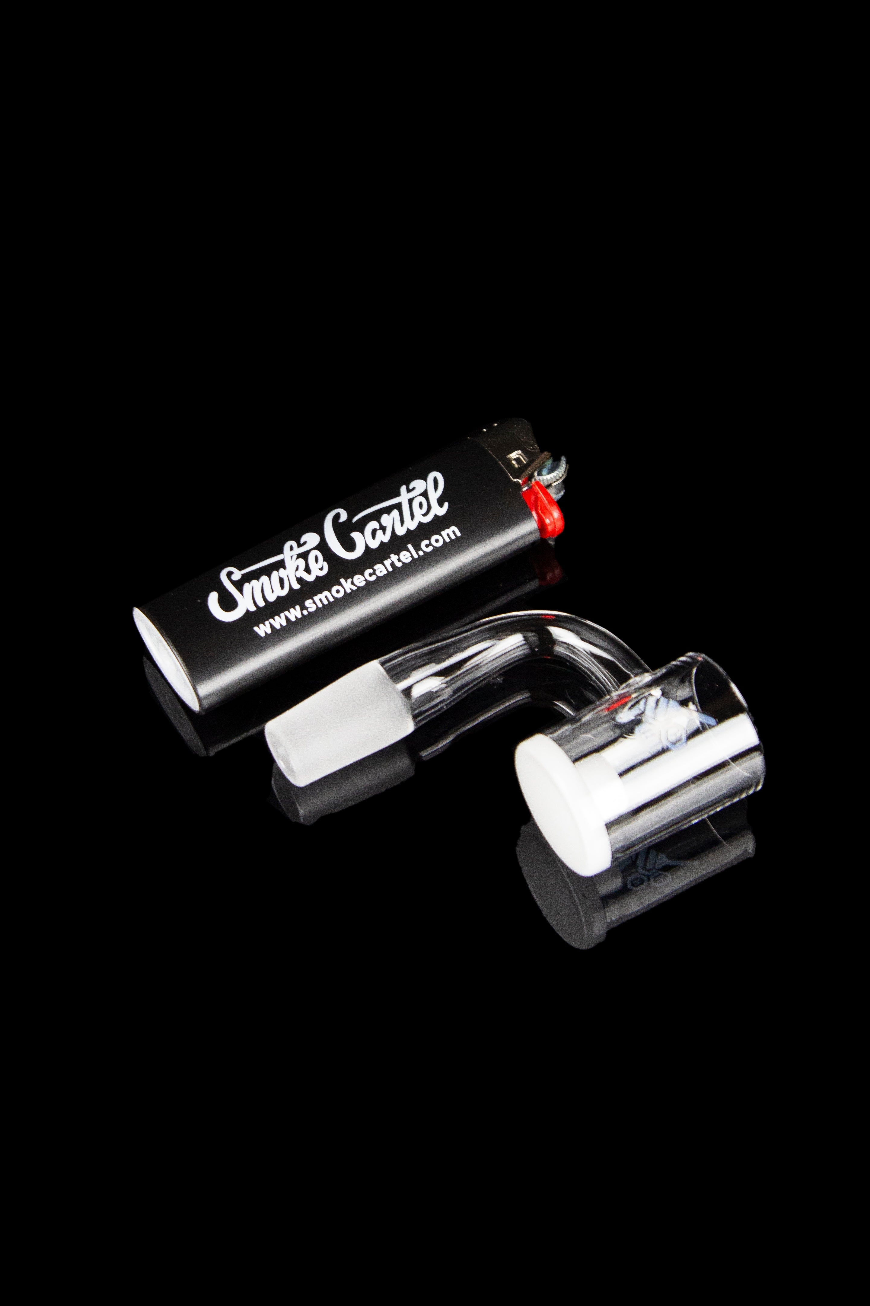 Black cannabis bubbler with clear glass chamber, branded with "Smoke Cartel."