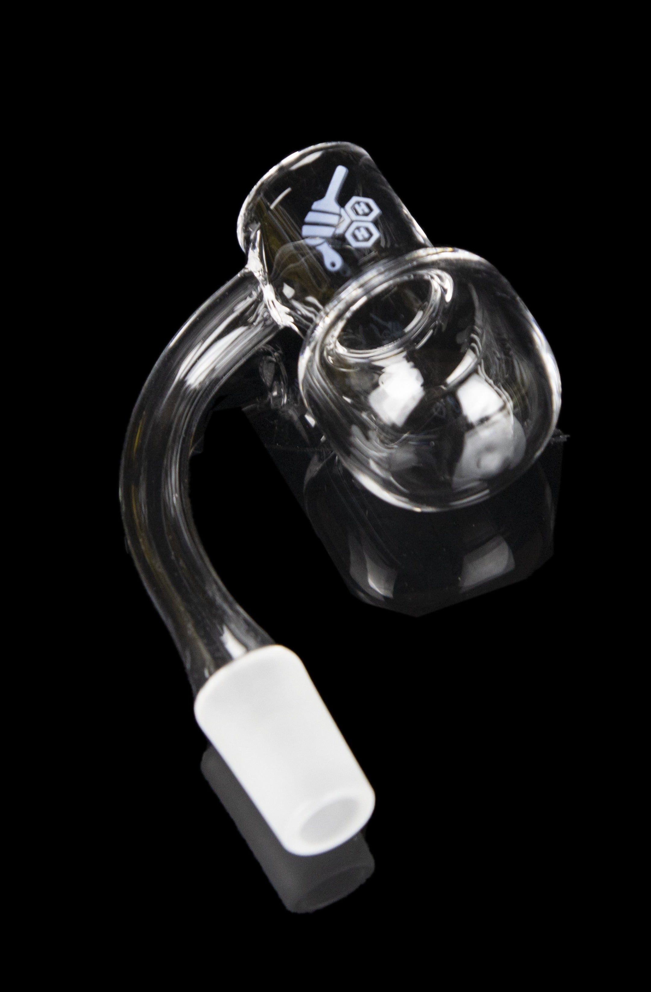 Clear glass dab rig with a white mouthpiece, isolated on a black background.