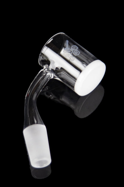 Clear glass dab rig with etched design, isolated on black.