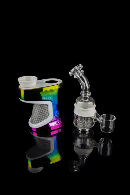 Daab cannabis e-rig with various glass attachments displayed on a reflective surface.