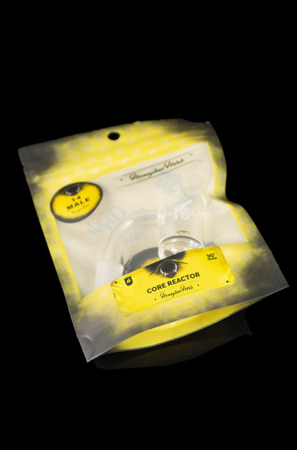 Yellow packaging for “Core Reactor” cannabis accessory by Honeybee Herbs, containing a glass piece.