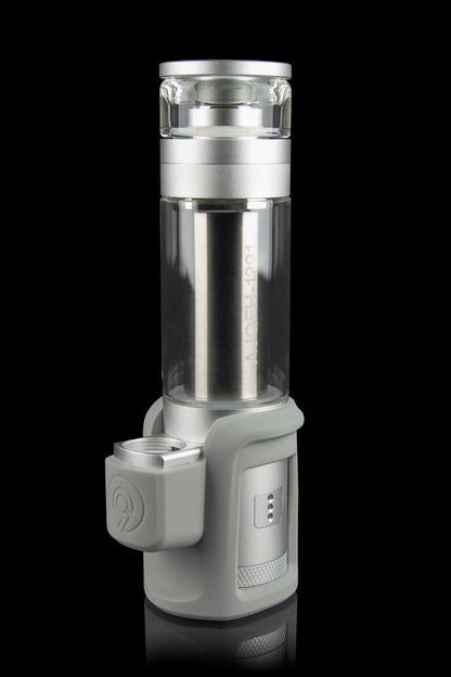 Silver cannabis vaporizer with a glass chamber and digital display, isolated on a black background.