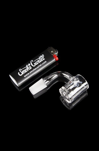 Glass dab rig with quartz insert and carb cap, presented with branded packaging.