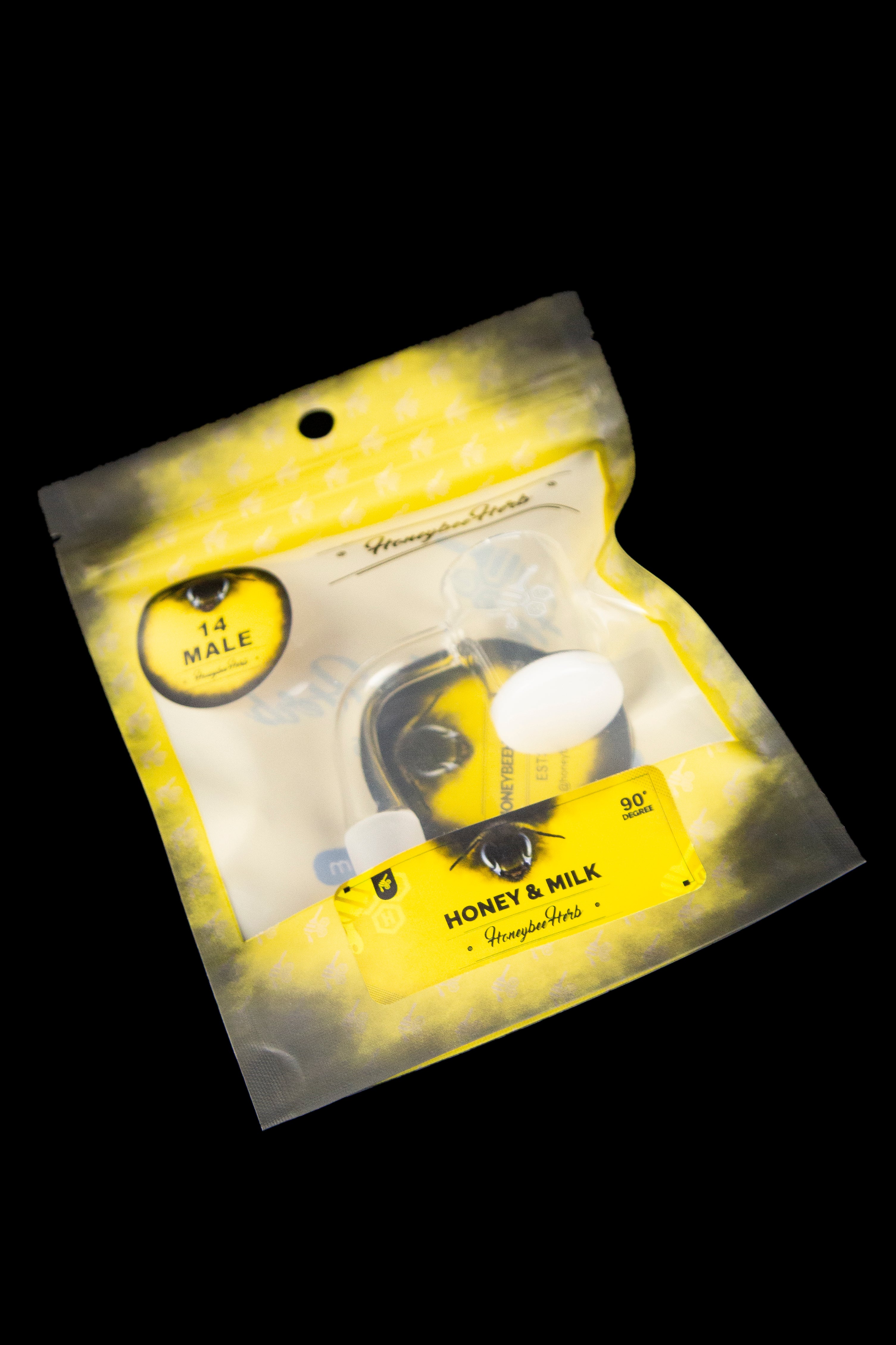 Yellow foil bag of "Honey & Milk" cannabis concentrate with a cartoon bee illustration.