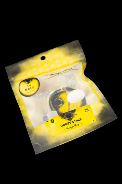 Yellow foil bag of "Honey & Milk" cannabis concentrate with a cartoon bee illustration.