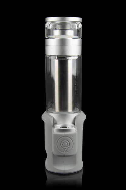 Silver and frosted glass cannabis oil rig with a cylindrical shape and visible internal components, against a black background.