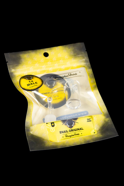Gold mylar bag containing a cannabis dab rig with branding for “Honeybee Herb” and “Enail Original.”