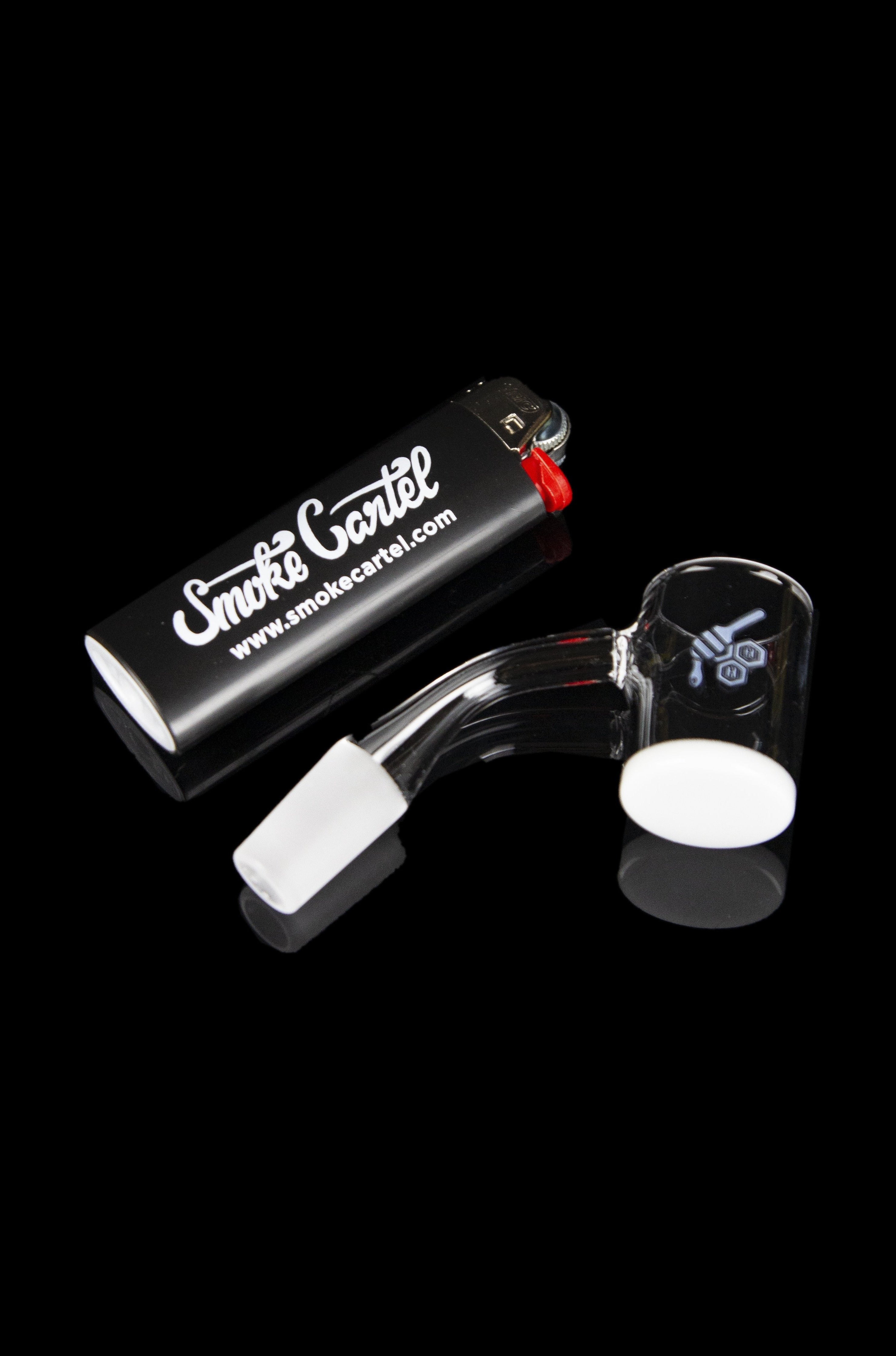 Glass dab rig with accessories on a black background.