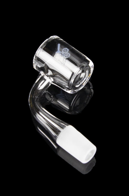 Clear glass cannabis dab rig concentrate bowl against a black background.