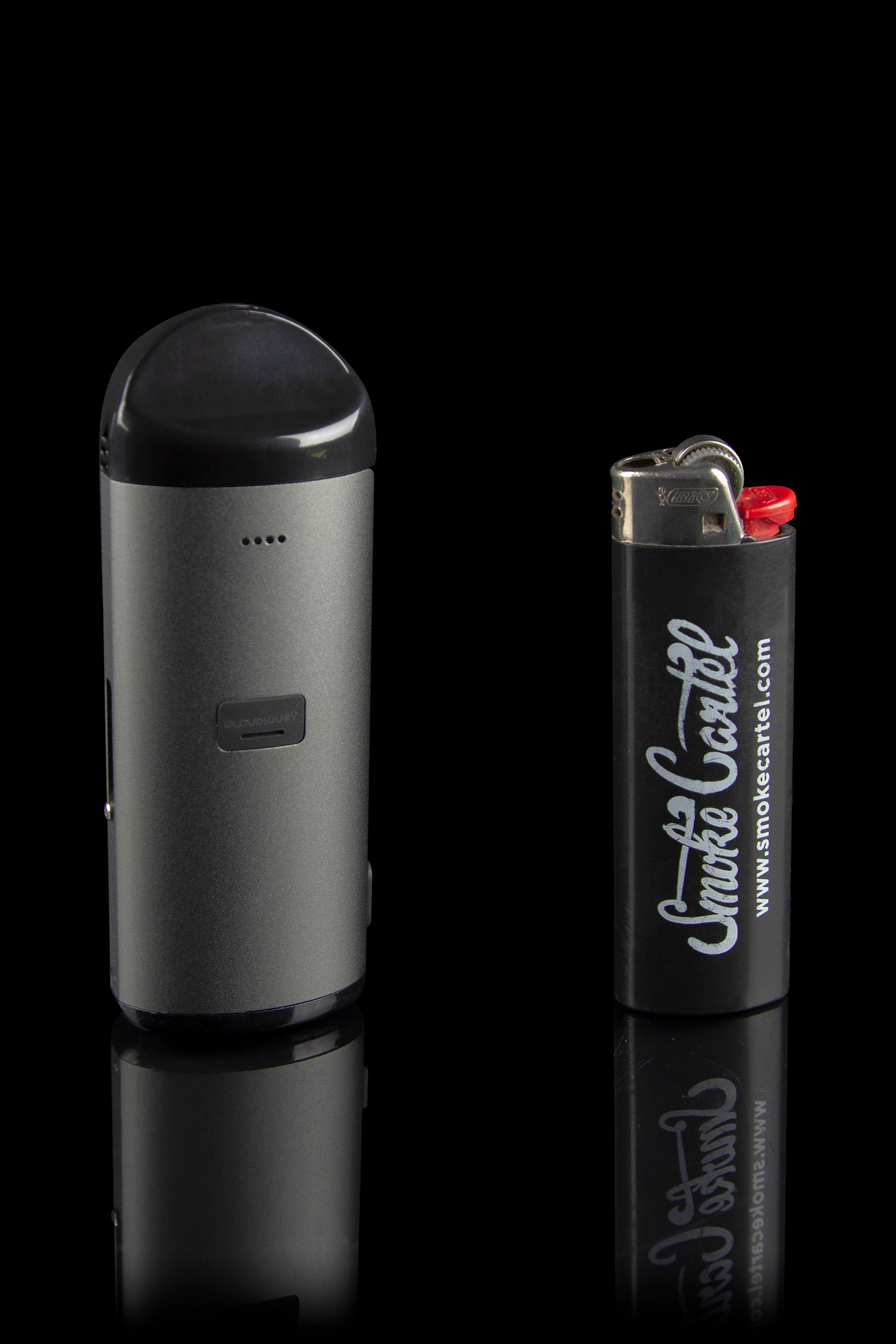 Black cannabis vaporizer pen and lighter with “Smoke Cartel” branding, displayed on a reflective surface.