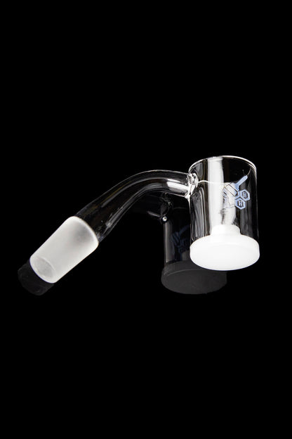 Clear glass dab rig with angled mouthpiece and quartz insert.
