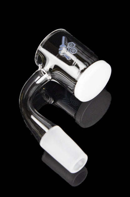 Clear glass dab rig with a bent neck and white accent pieces, isolated on a black background.