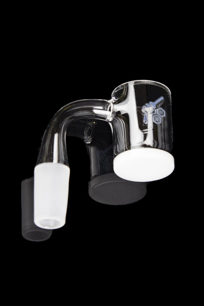 Clear glass dab rig with a quartz insert, isolated on a black background.