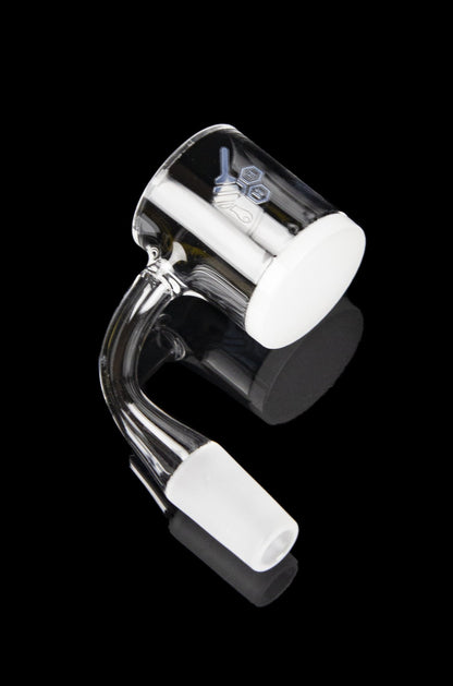 Clear quartz banger with white carb caps for cannabis concentrates.