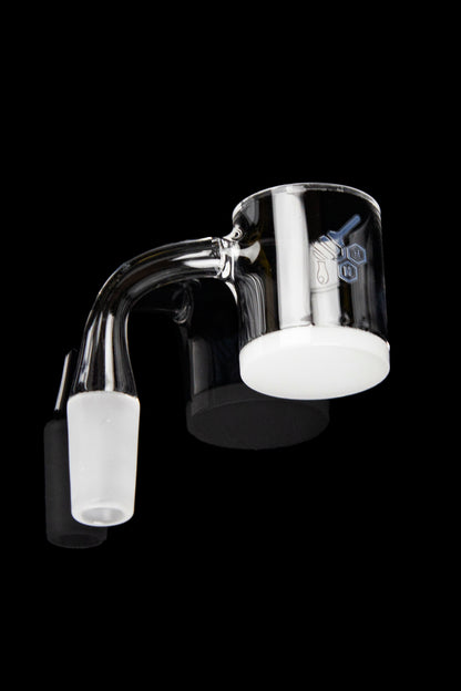 Clear glass dab rig with angled mouthpiece and carb cap on black background.