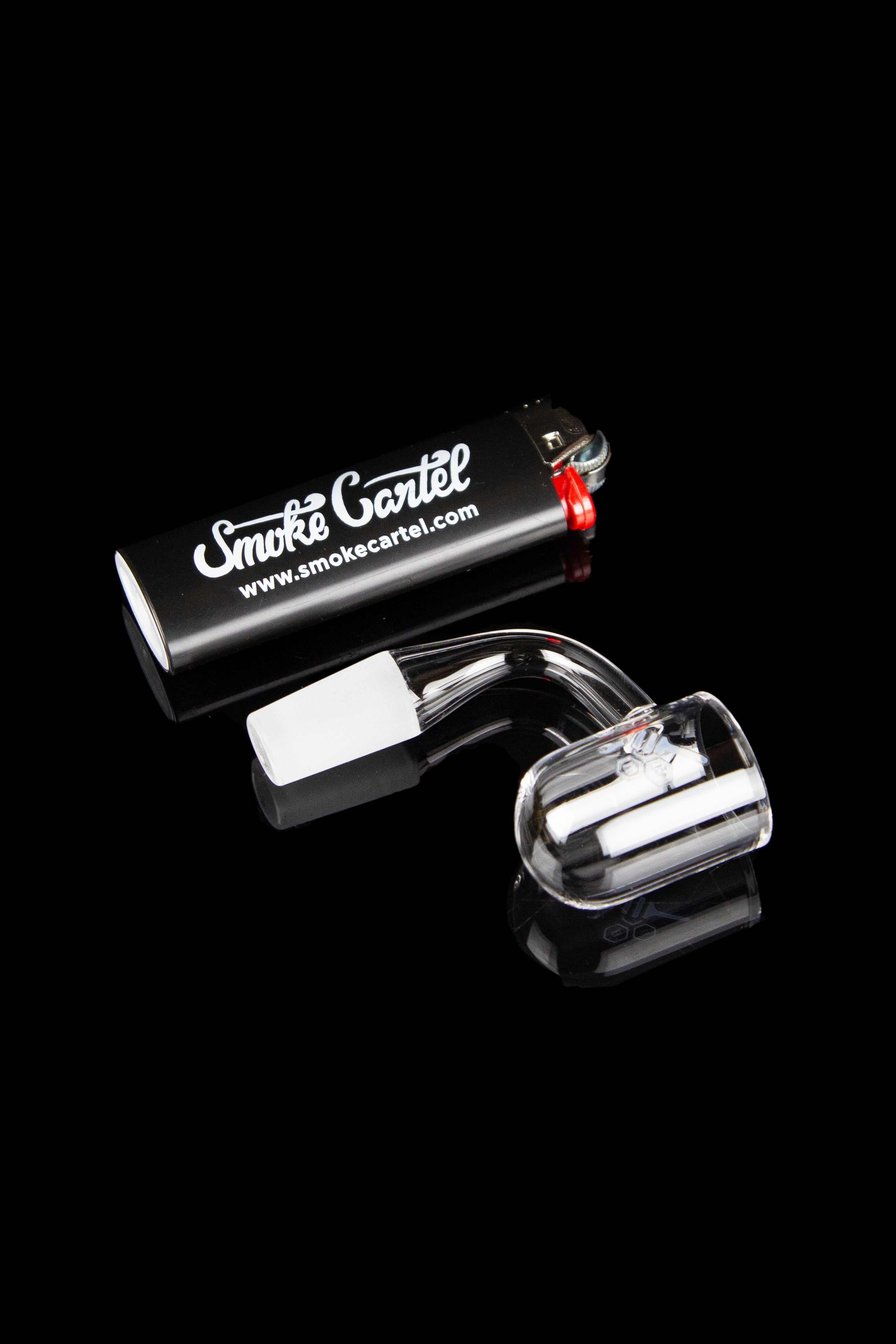 Quartz banger with carb cap and cotton swab, displayed on a reflective black surface with "Smoke Cartel" branding.