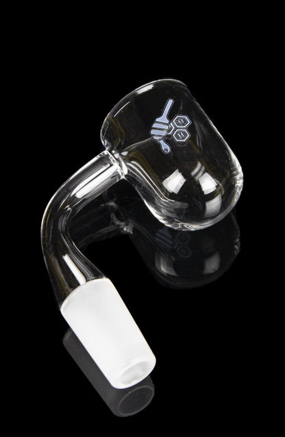 Clear quartz dab rig insert with etched design, against a black background.