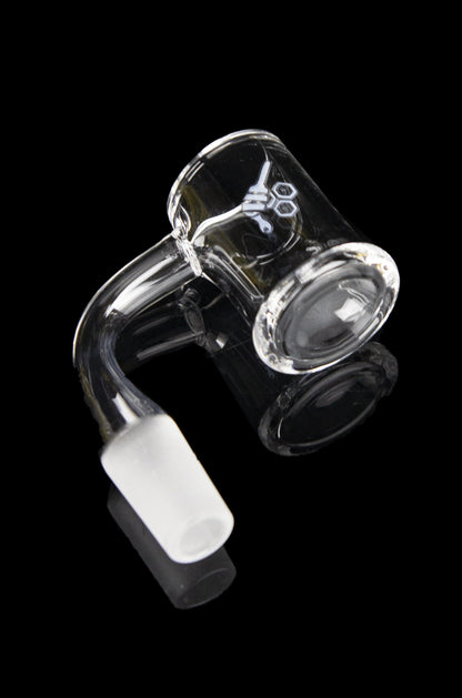 Clear glass dab rig with a bent neck and white mouthpiece against a black background.