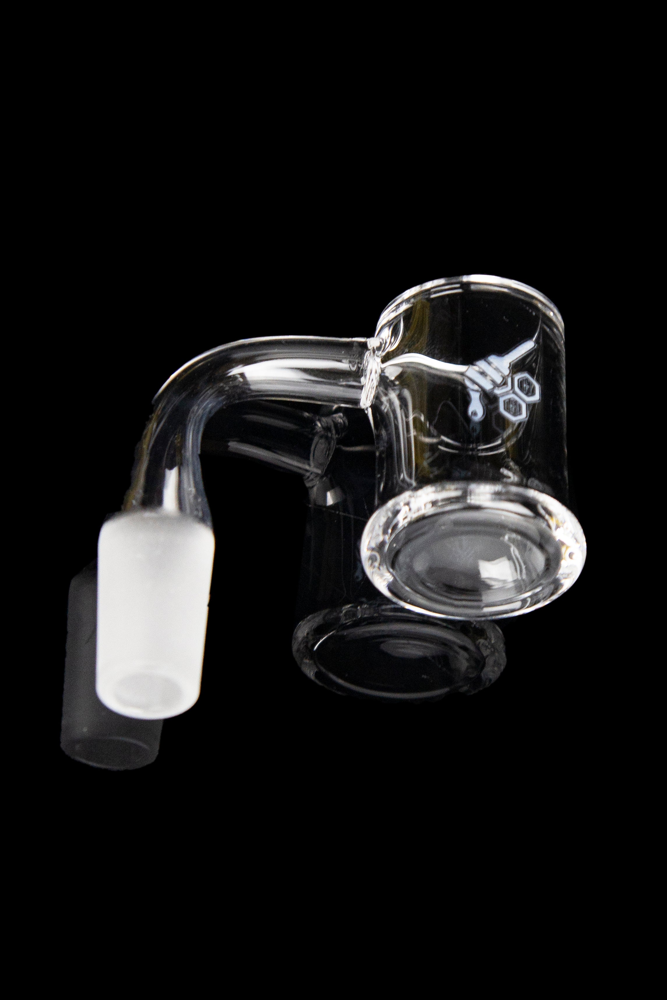 Clear glass dab rig with a quartz insert against a black background.